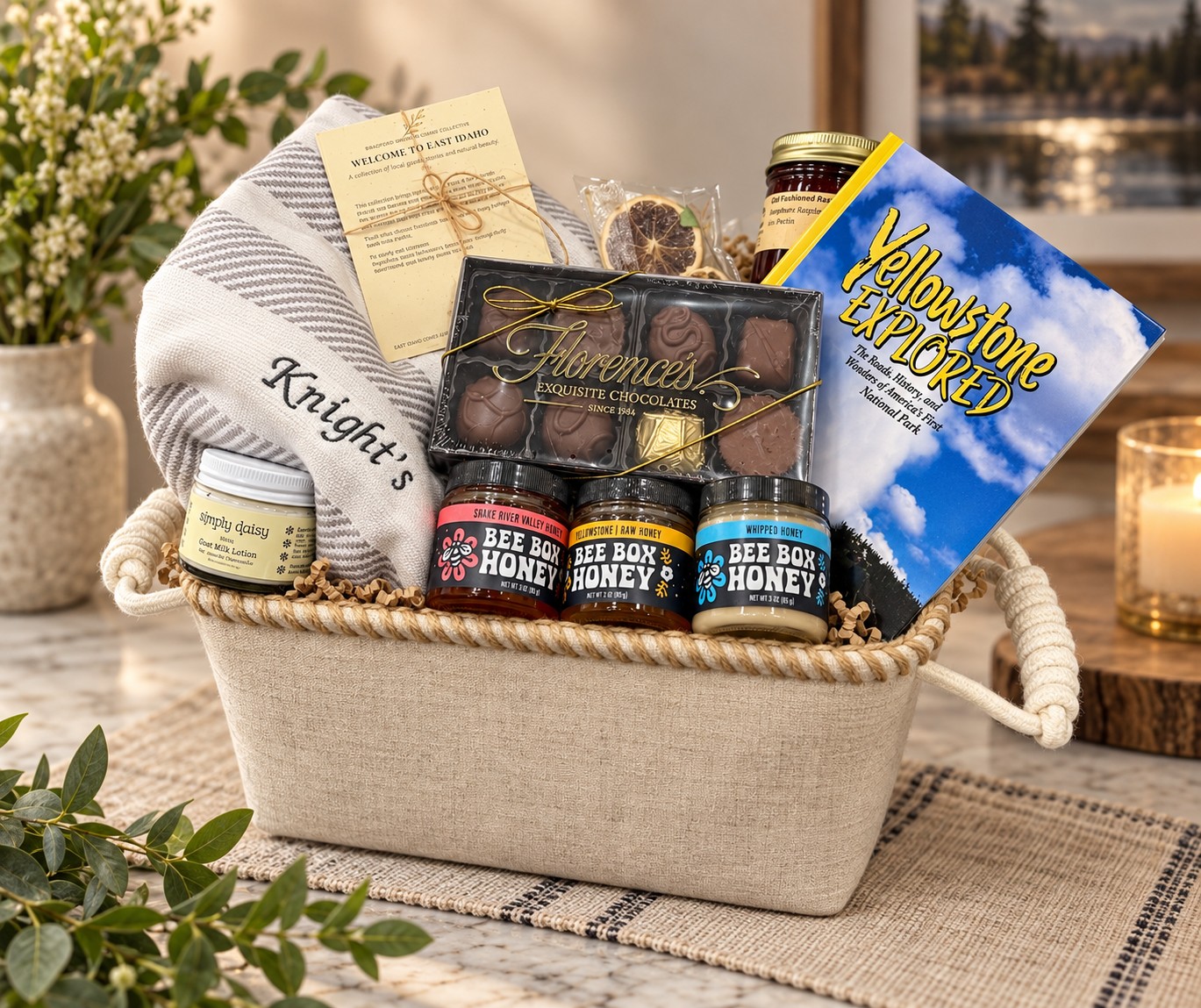 A Welcome Collection basket with a monogrammed cotton hand towel, Simply Daisy goat milk lotion, Florence&rsquo;s chocolates, the three Bee Box honeys, raspberry jam and Yellowstone Explored