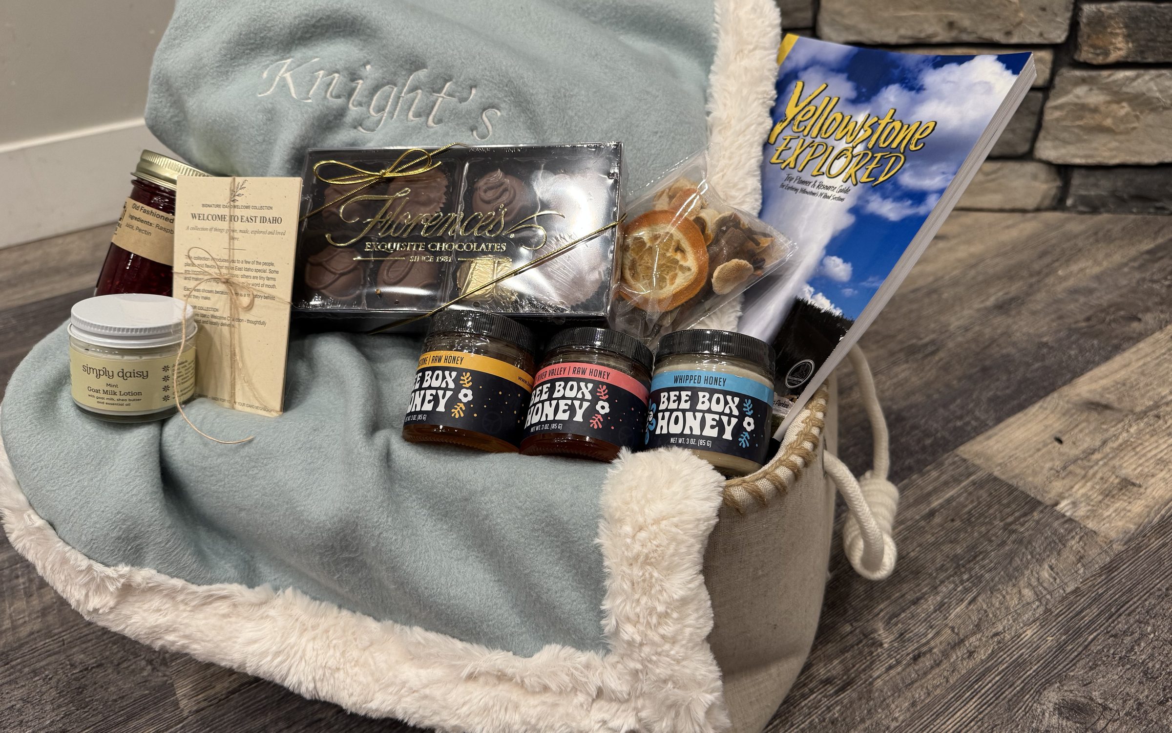 The Signature collection open, with the blanket, honey, chocolates, lotion, jam and guide in place